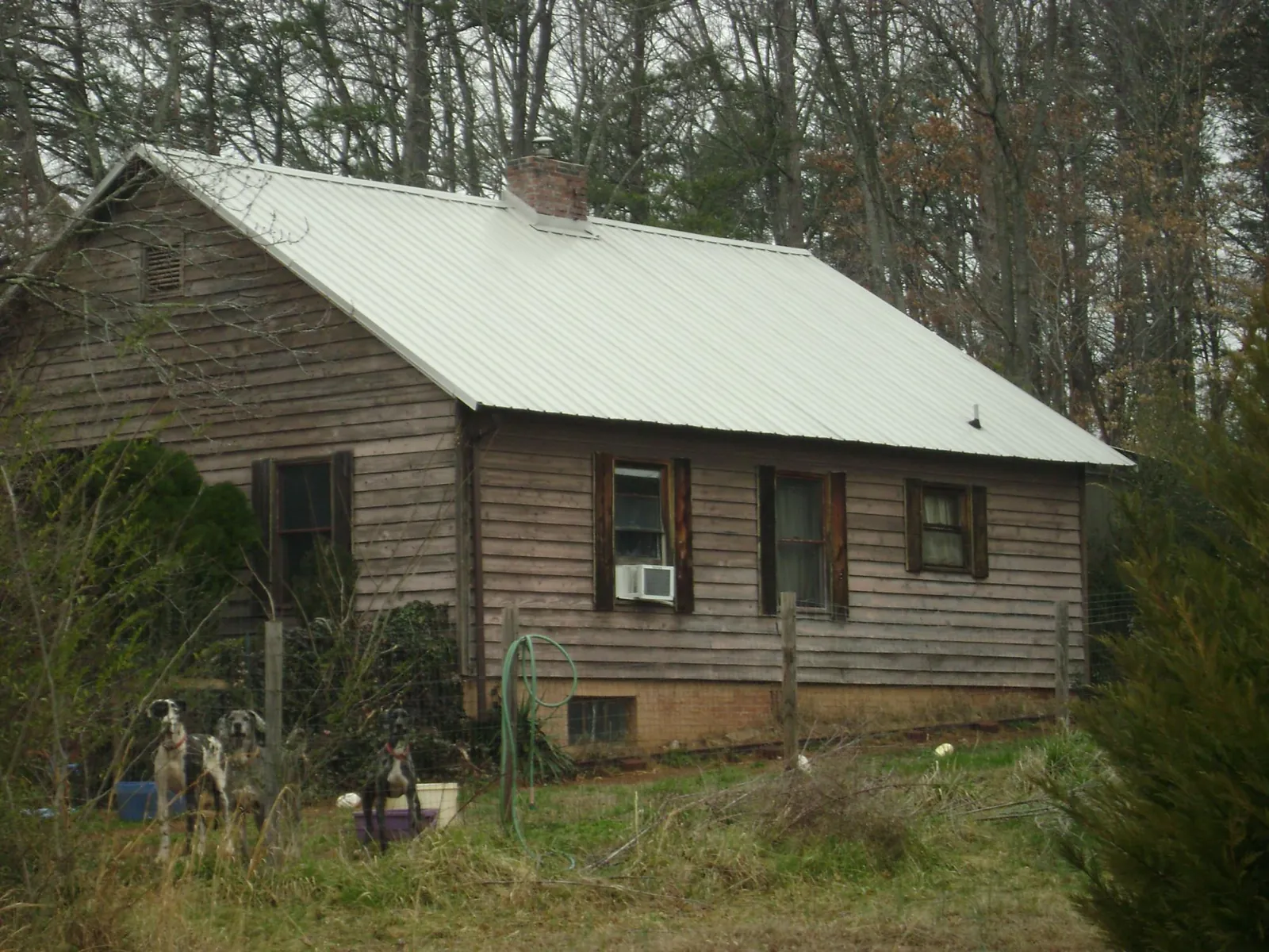 White metal roof on an old wood sided farmhouse, from a Metal Roof Installation job in Saratoga Springs